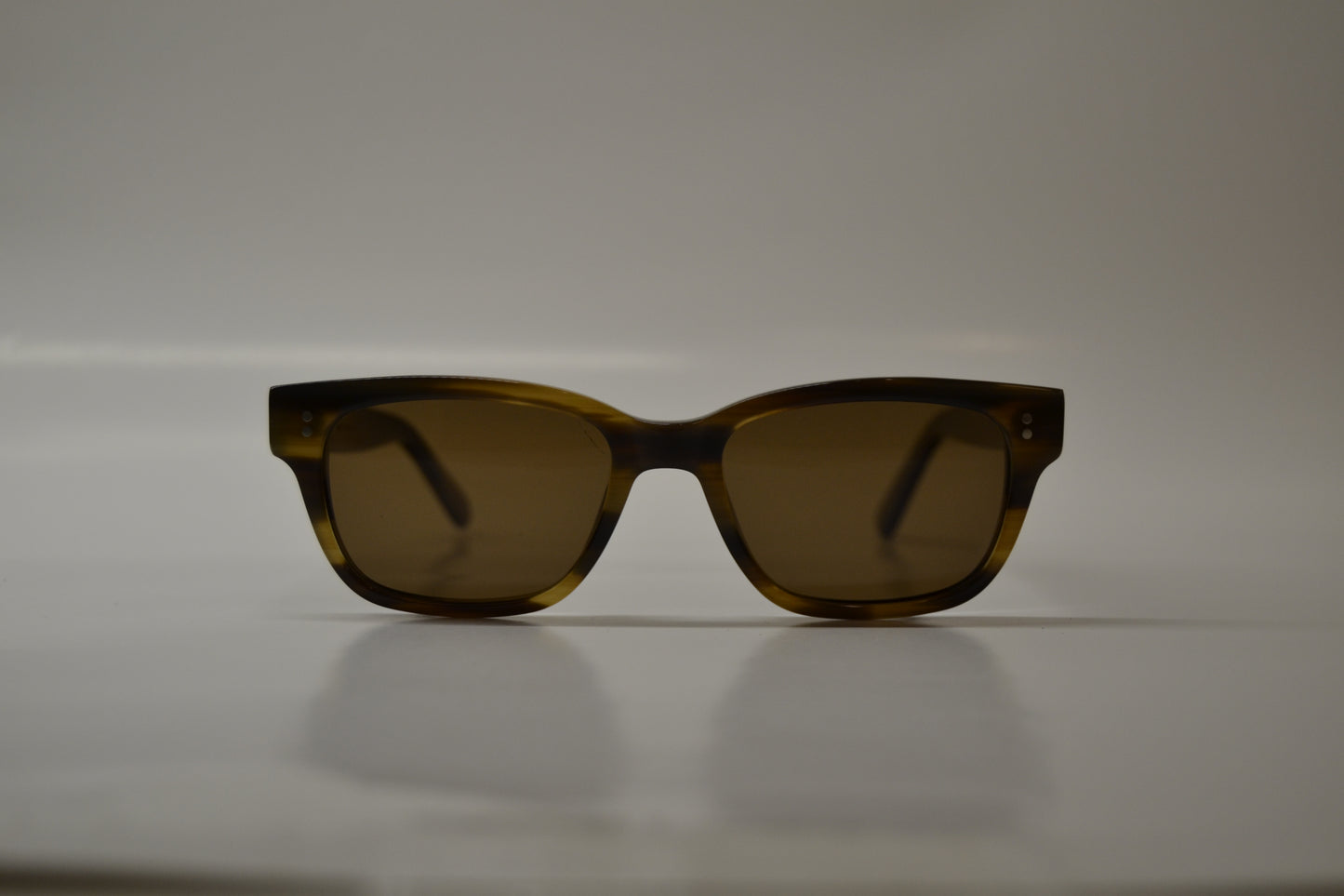 A pair of yellow-framed sunglasses with polarized lenses, displayed against a neutral background.
