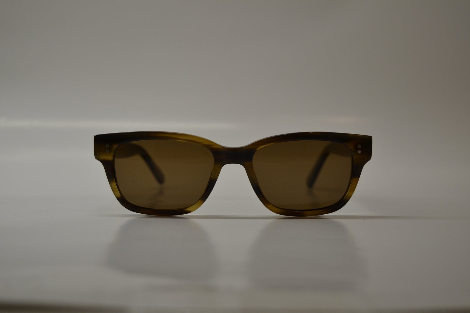 A pair of yellow-framed sunglasses with polarized lenses, displayed against a neutral background.