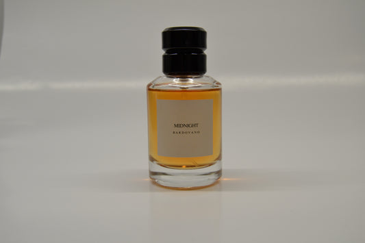 A bottle of perfume labeled 'Midnight' on a white background