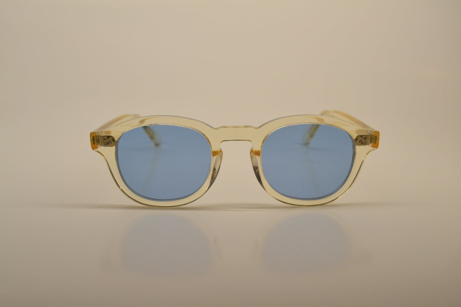 A pair of sunglasses with a gold frame and blue polarized lenses.