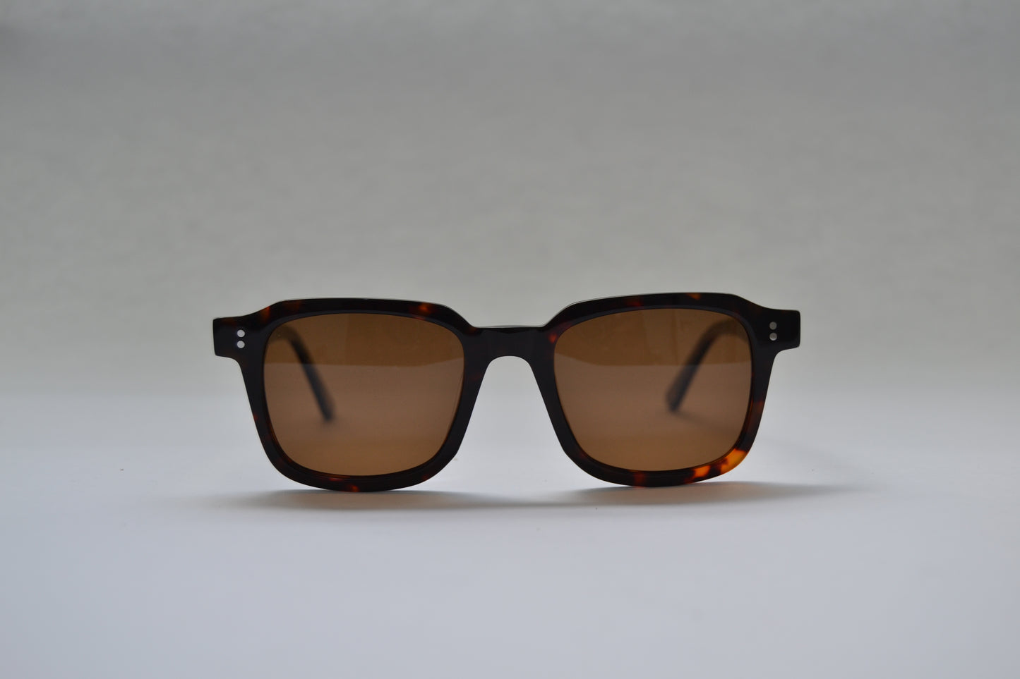 A pair of square-shaped, full frame metal sunglasses with polarized lenses and UV protection.