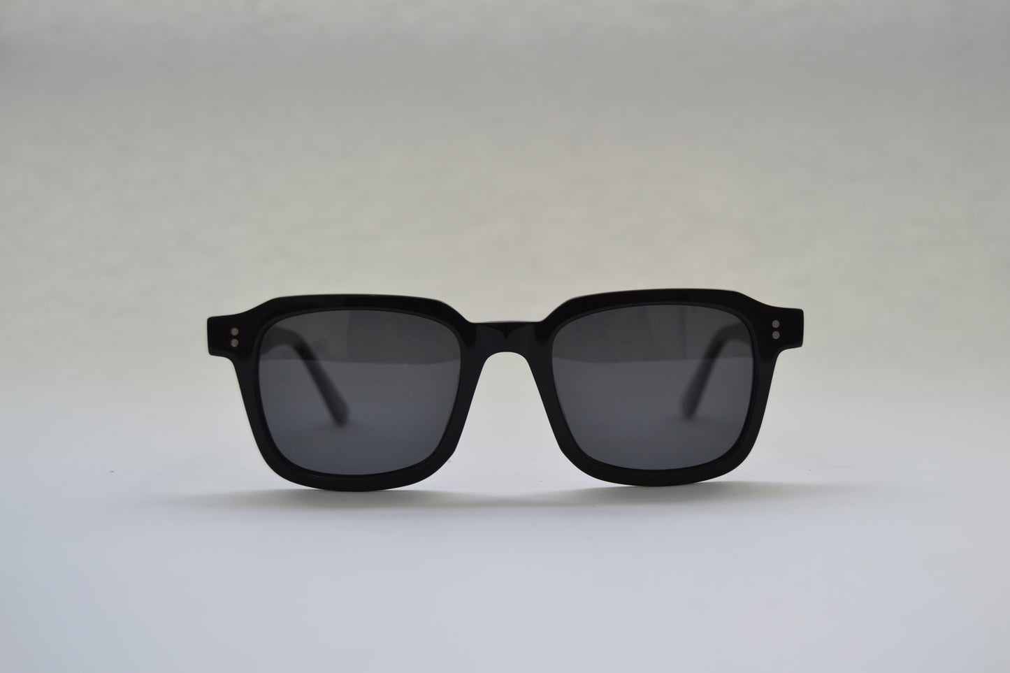 A pair of square-shaped, full frame metal sunglasses with polarized lenses and UV protection.