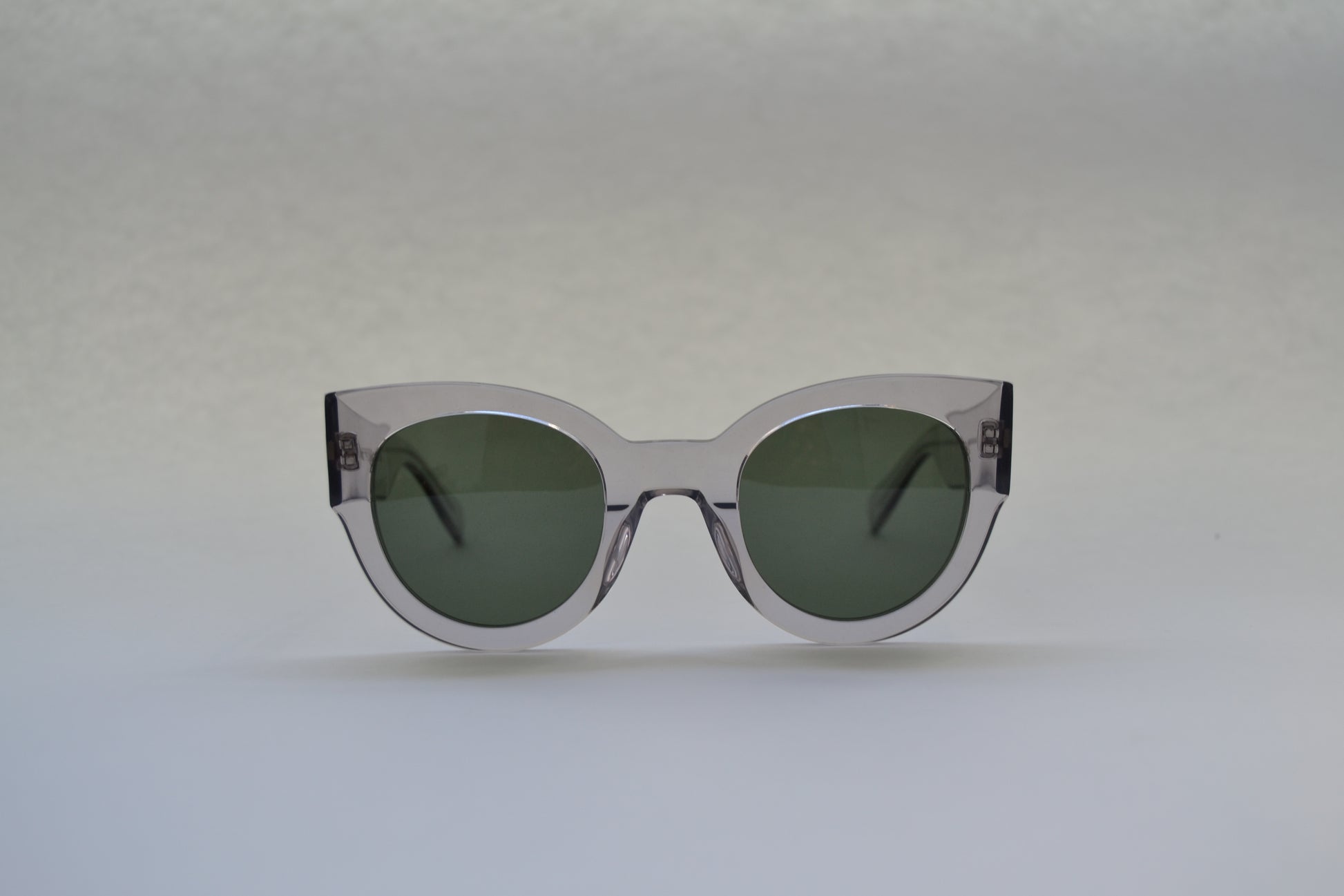 A pair of sunglasses with a patterned frame, front view on a white background