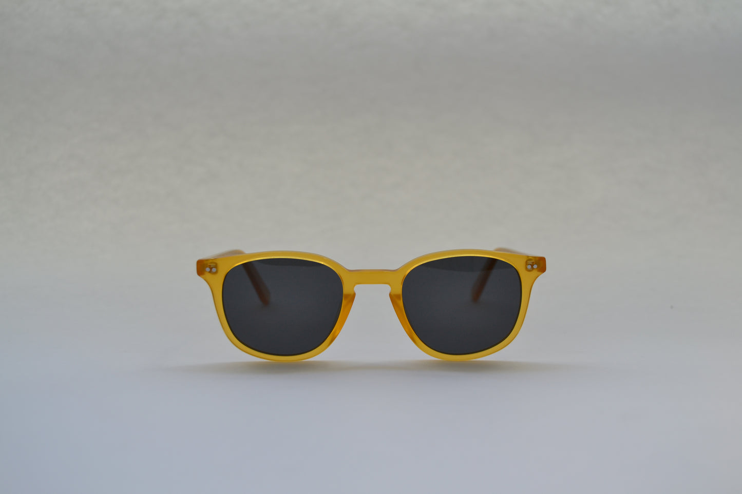 A pair of sunglasses with a black frame and patterned with a tortoiseshell design, featuring polarized lenses.